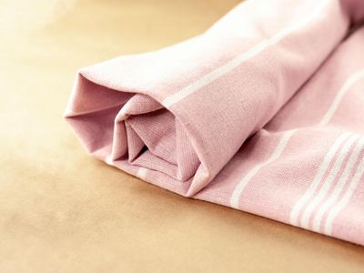 A bottle of water next to a folded towel